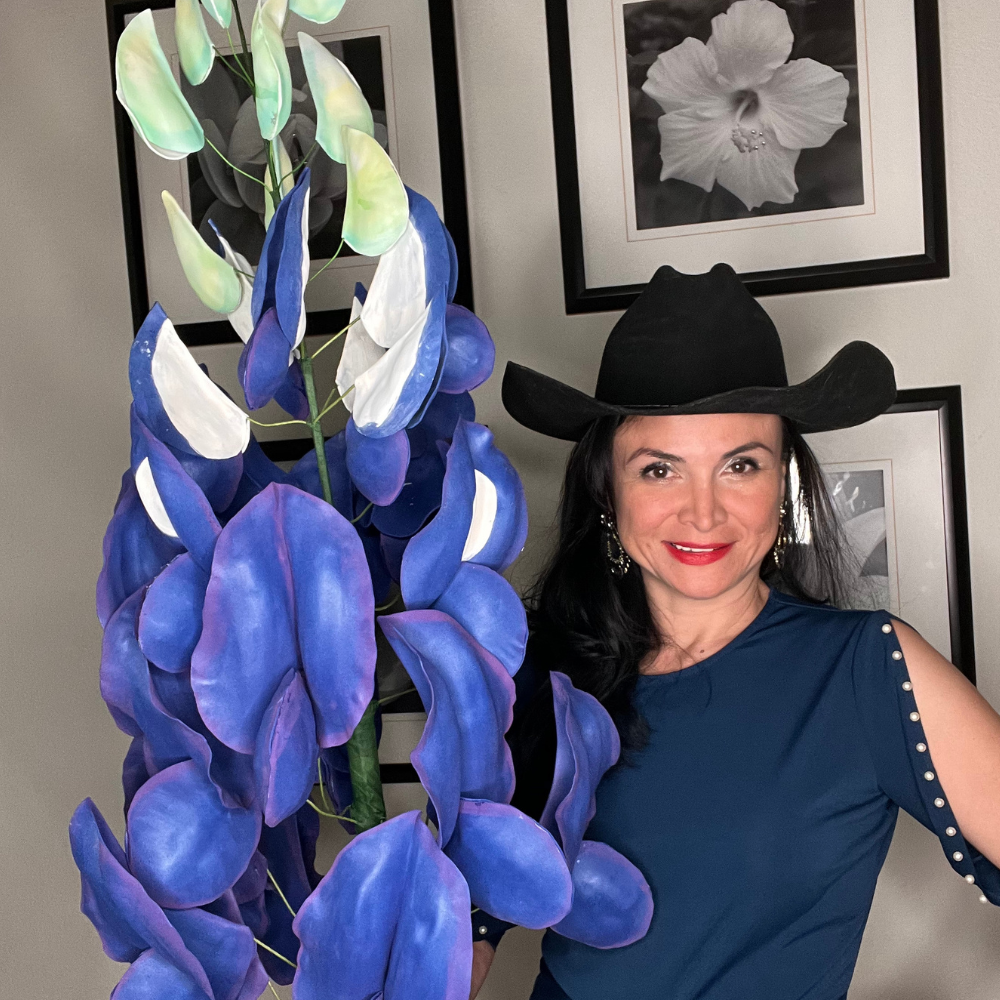 Completed giant Texas bluebonnet foam flower with blue-purple blooms and green leaves on black background