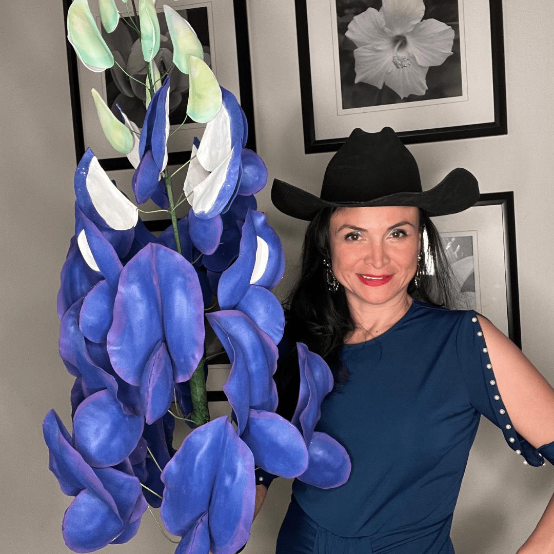 Completed giant Texas bluebonnet foam flower with blue-purple blooms and green leaves on black background