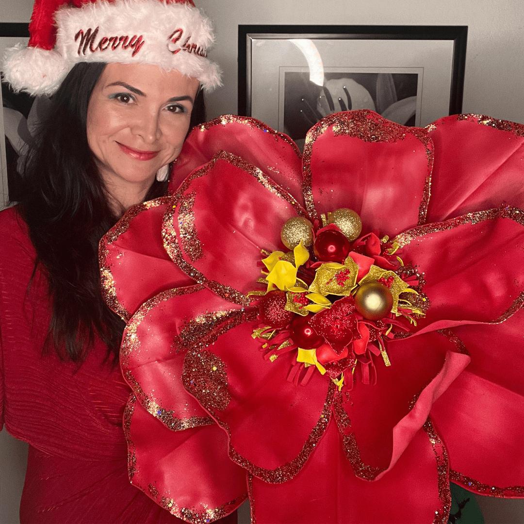 Giant white Christmas magnolia foam flower with green leaves and red berries on black background for holiday decor