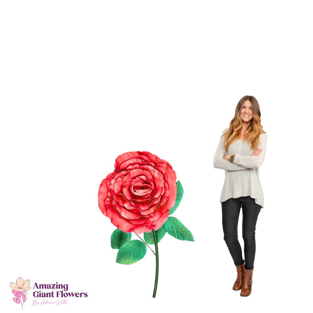 Woman holding completed giant pink garden rose foam flower showing full bloom with layered petals