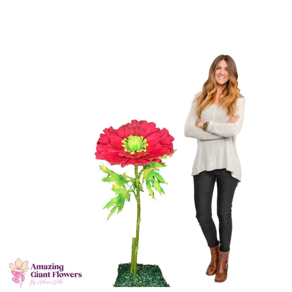 Woman holding oversized red poppy foam flower demonstrating scale of completed DIY flower kit