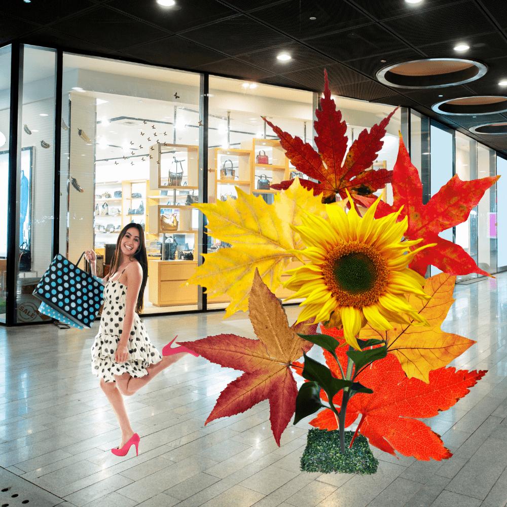 Fall seasonal display with giant foam flowers in autumn orange, red, and gold colors with harvest decorations