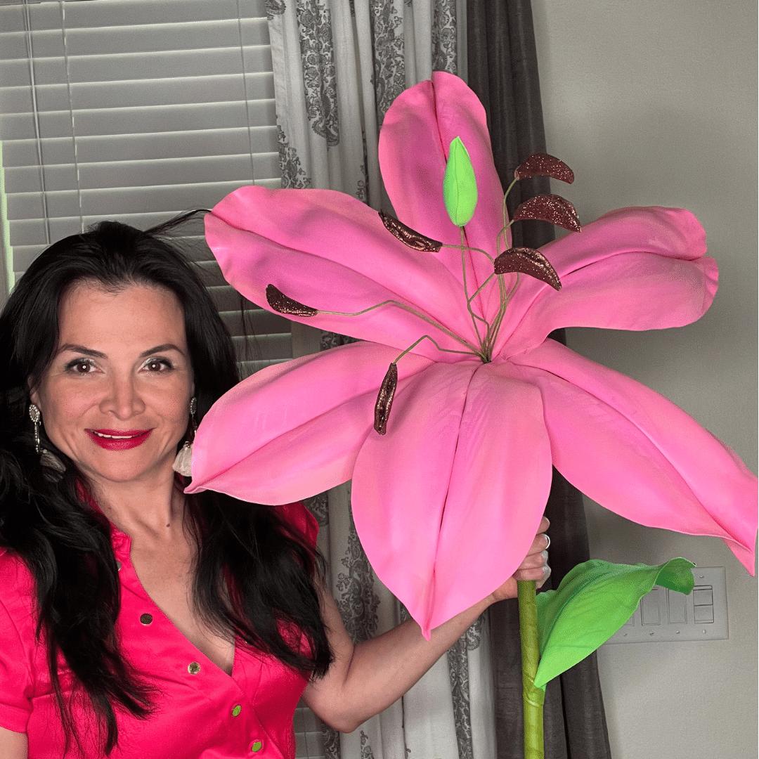 Giant white lily foam flower with green leaves on black background from DIY craft flower kit