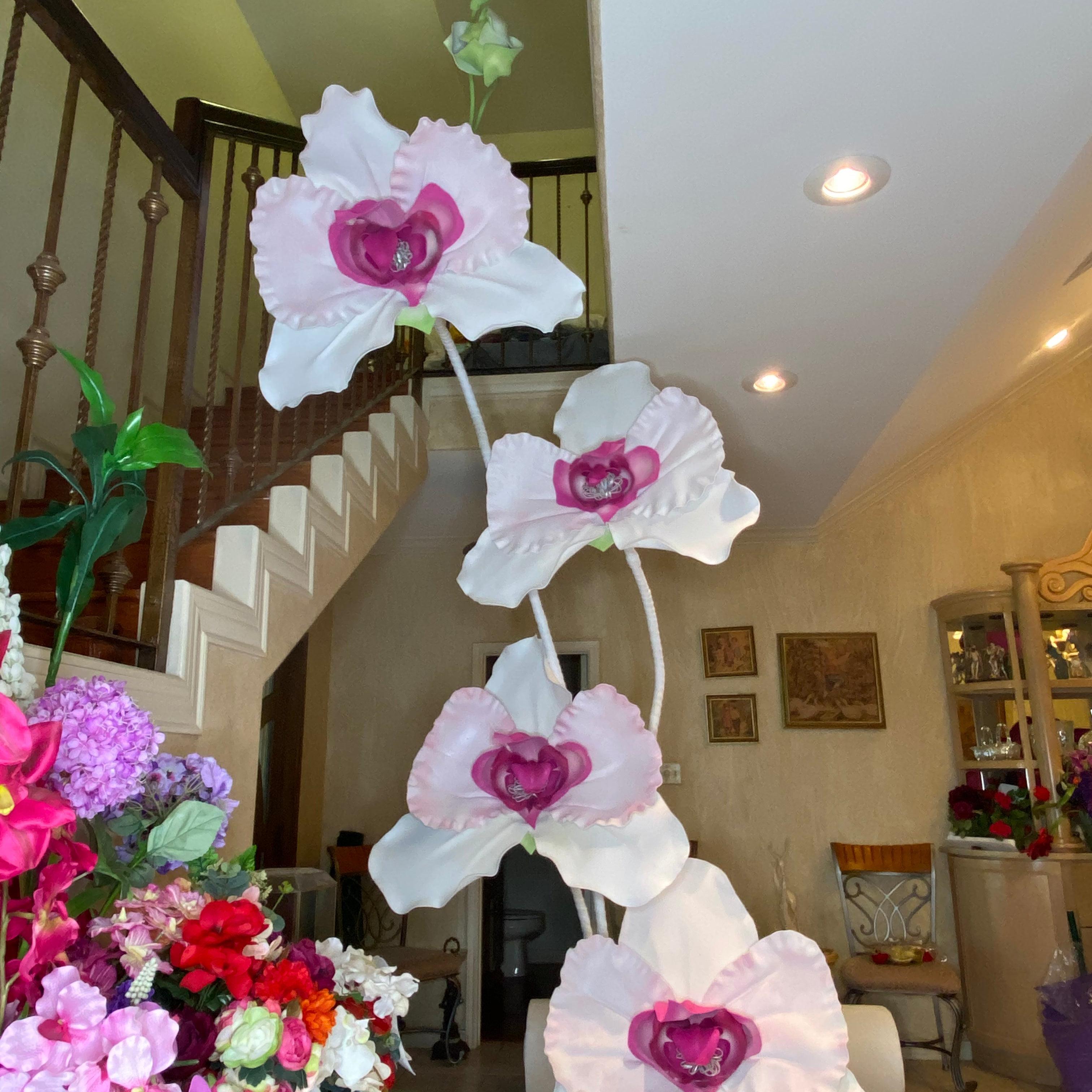 11-foot tall giant white orchid arrangement with cascading phalaenopsis blooms for luxury hotel and event decor